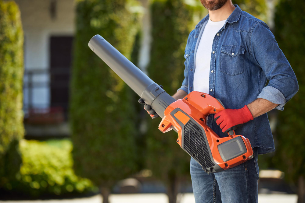 bearded-male-gardener-in-gloves-holding-powerful-cordless-leaf-blower-outdoors-crop-view-of-handyman.jpg